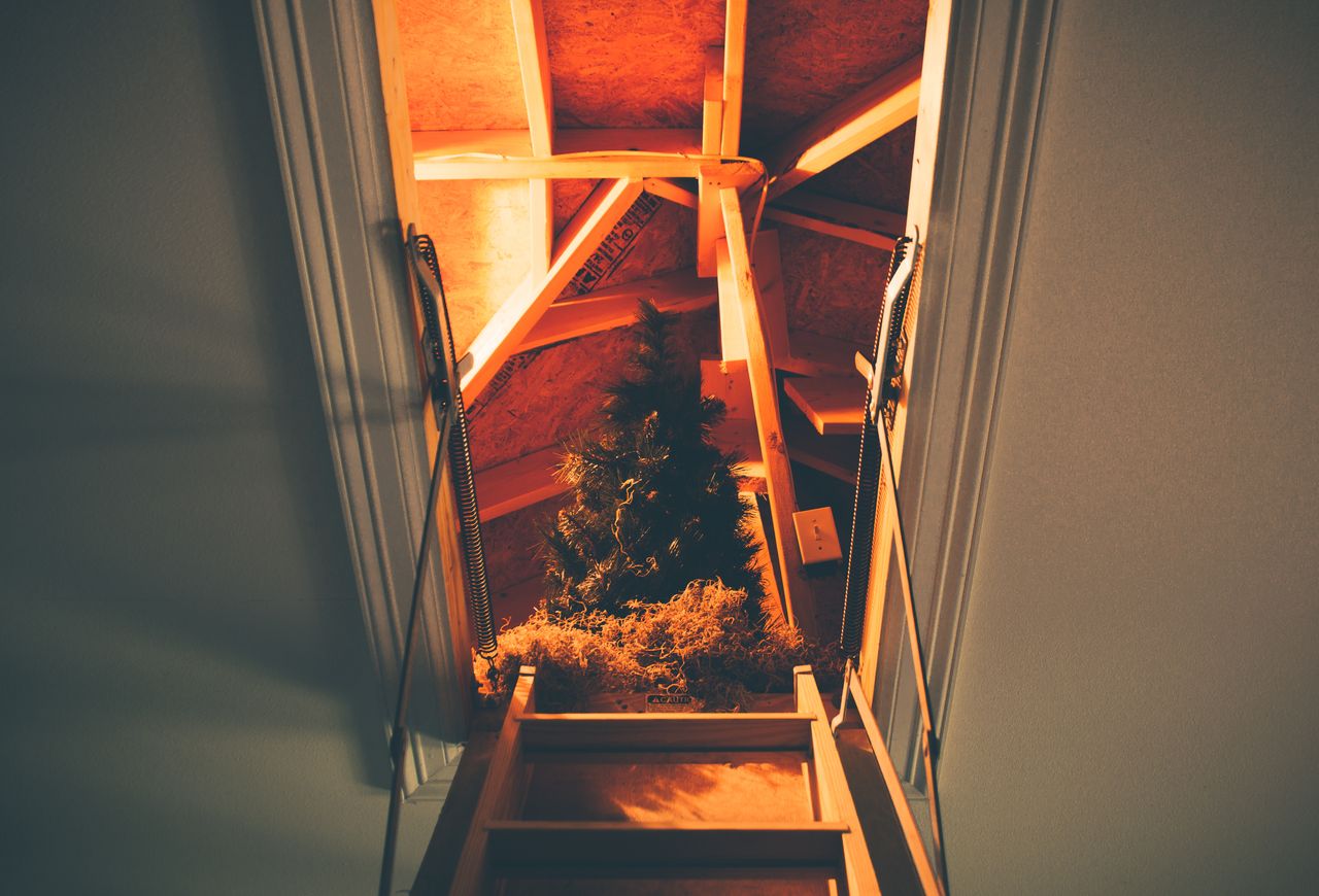 A folding loft ladder fitted into a landing ceiling