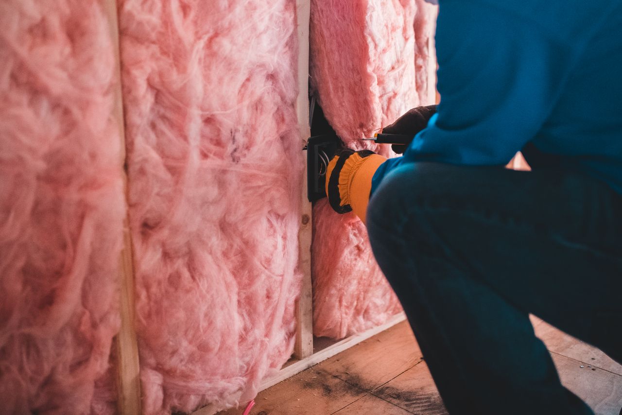 An installer laying loft boards over insulation